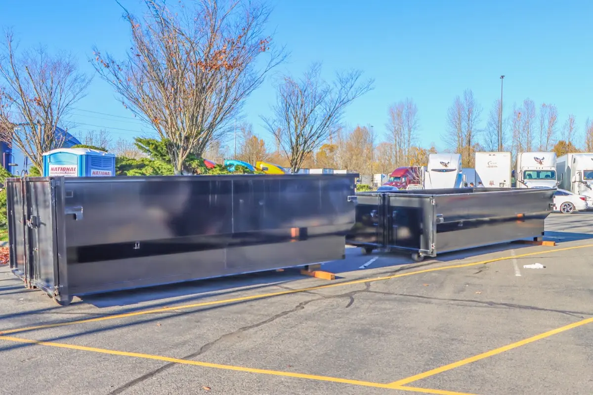 Professional dumpster rental service with roll-off container on residential driveway in Rayne